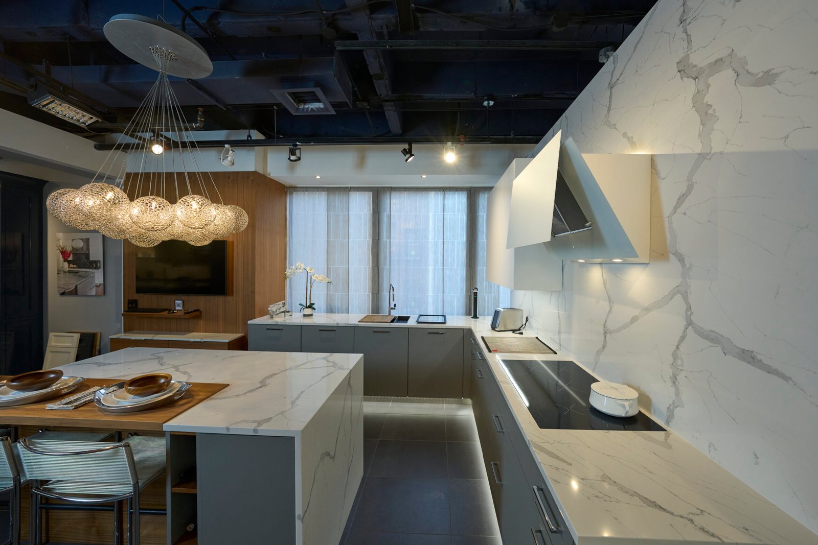 Quartz countertop island floor to ceiling slab wall