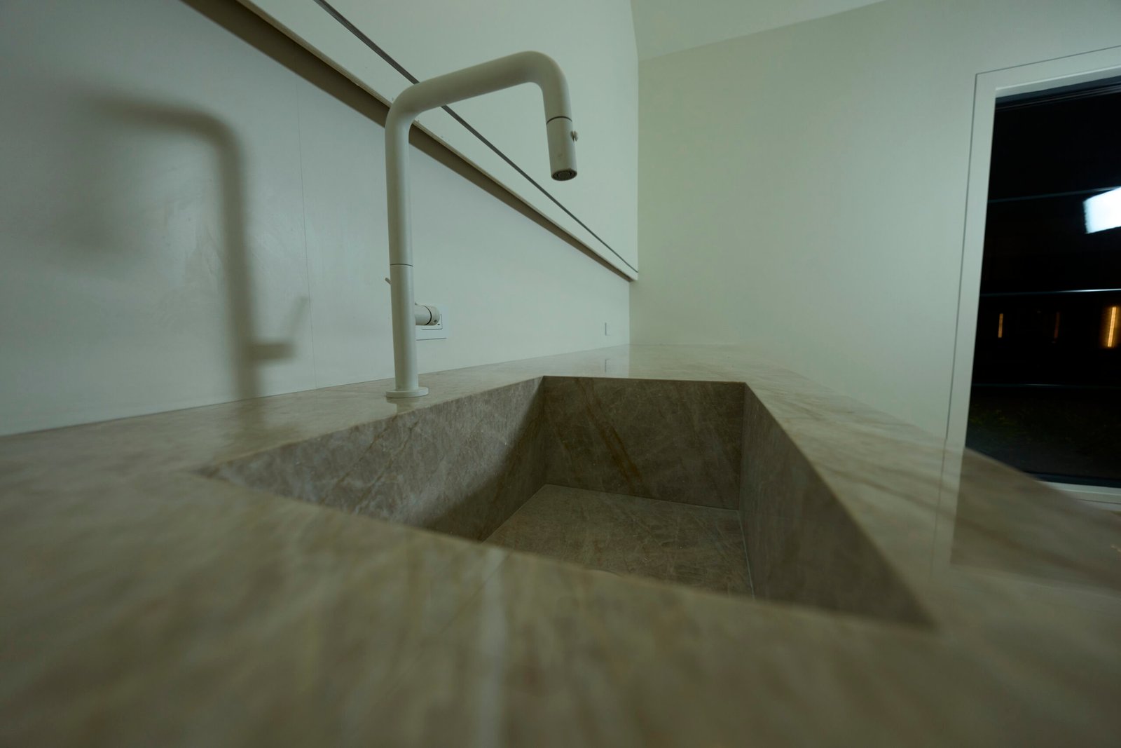 Laundry room quartzite integrated sink white faucet low angle