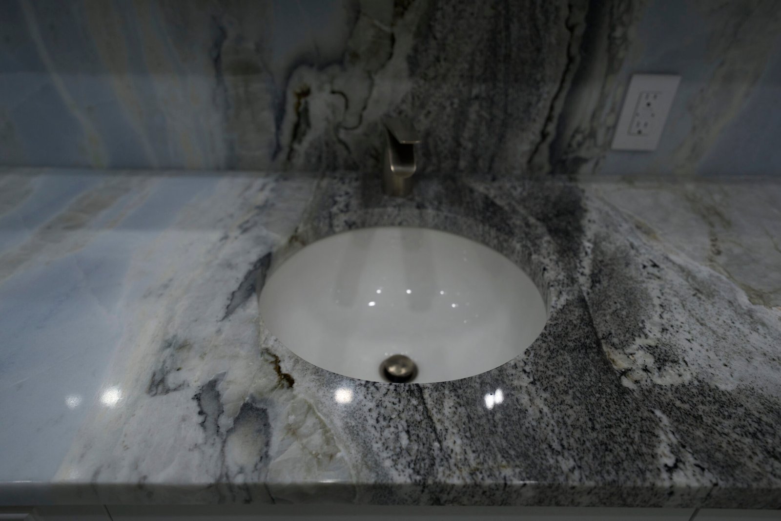 Natural stone bathroom vanity countertop undermount sink blue grey veined closeup