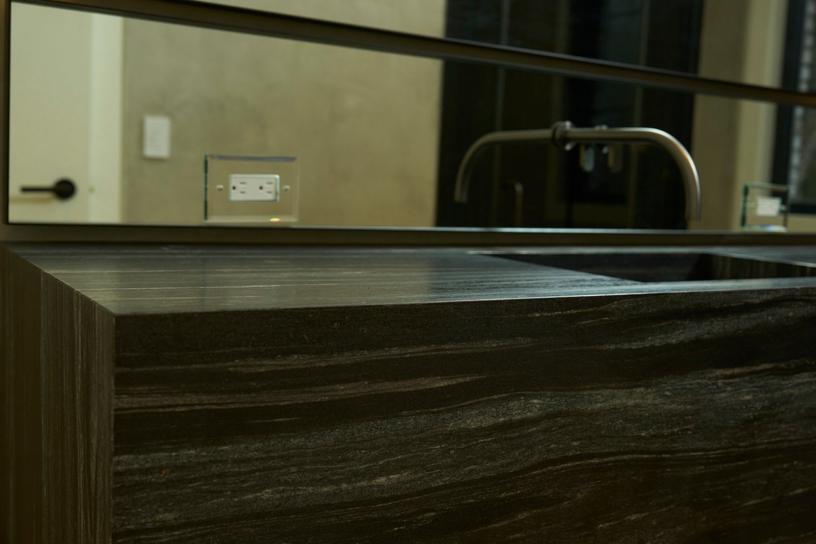 Natural stone dark vanity countertop waterfall edge integrated sink