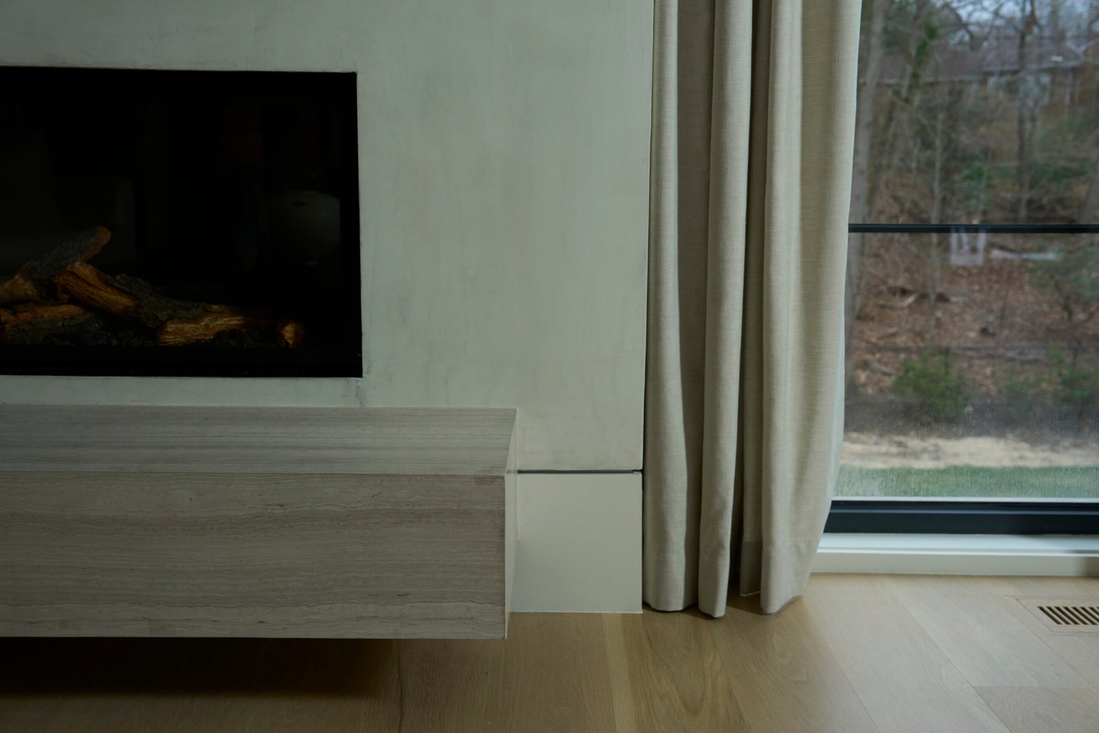 Natural stone fireplace hearth floating shelf edge detail