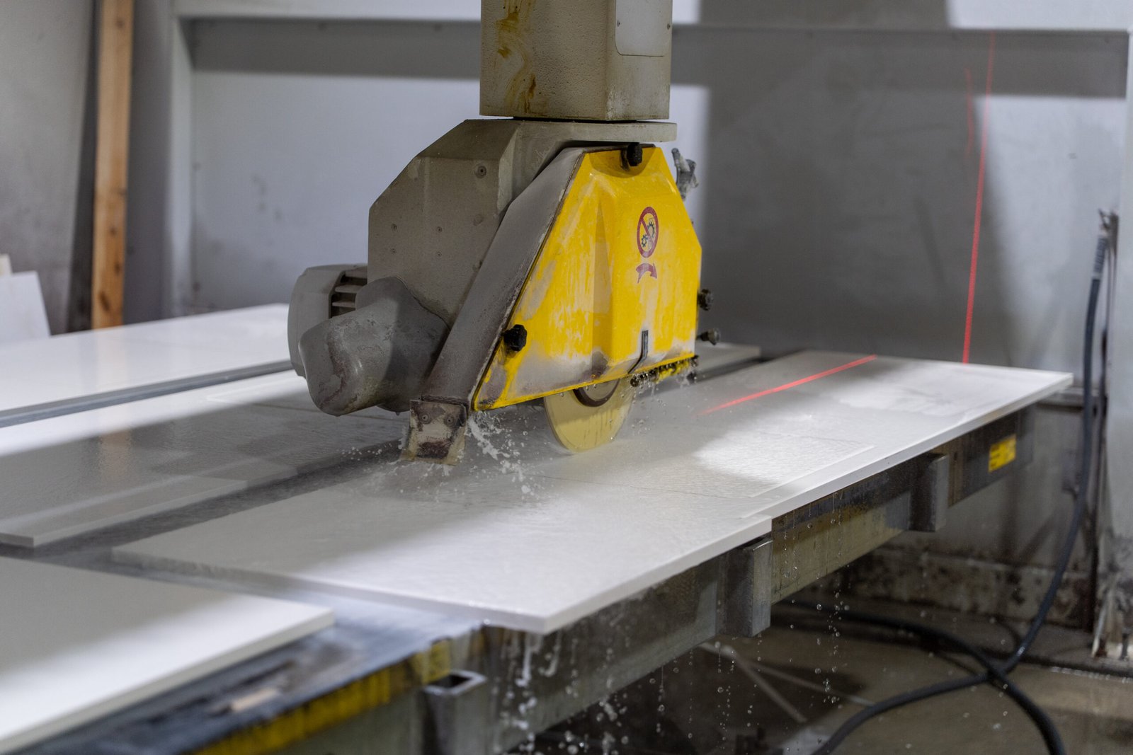 CNC bridge saw cutting a stone slab in close-up